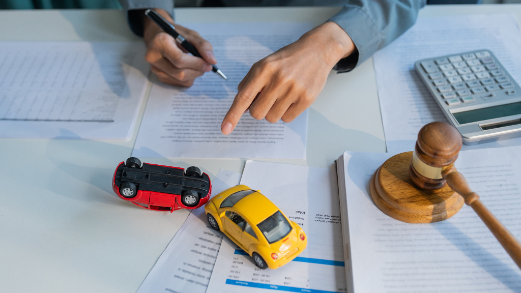 Finger choosing between colorful toy cars to represent choosing the right car accident lawyer